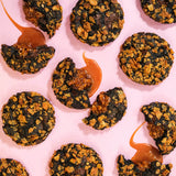 Caramel Cornflake New York Cookie with dark chocolate base, caramel cornflake crunch filling, and crunchy toasted topping.